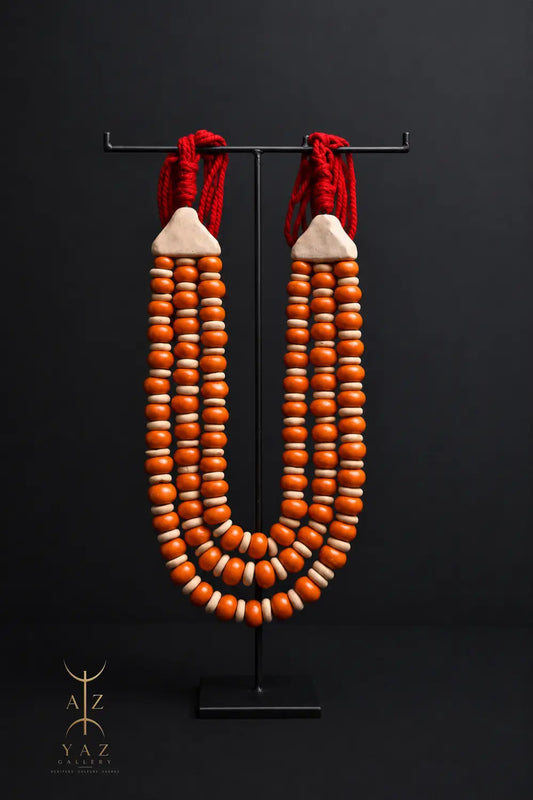 Sunset Ember Pendant Sculpture – Ivory & Orange Beads with Red Rope on Black Stand (62 x 34 cm)