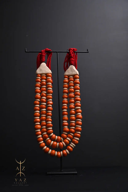 Sunset Ember Pendant Sculpture – Ivory & Orange Beads with Red Rope on Black Stand (62 x 34 cm)