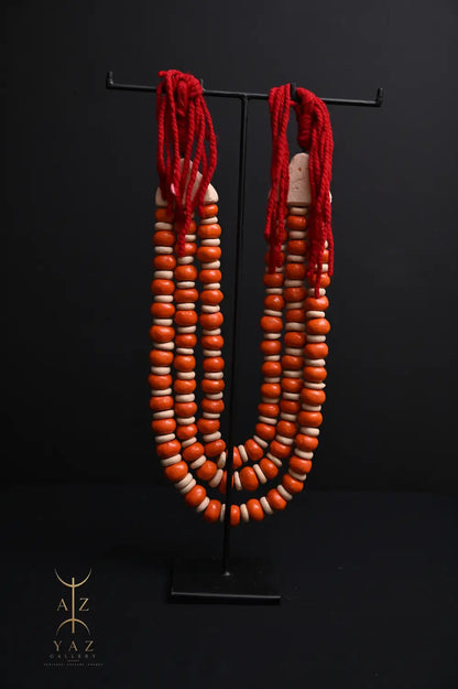 Sunset Ember Pendant Sculpture – Ivory & Orange Beads with Red Rope on Black Stand (62 x 34 cm)