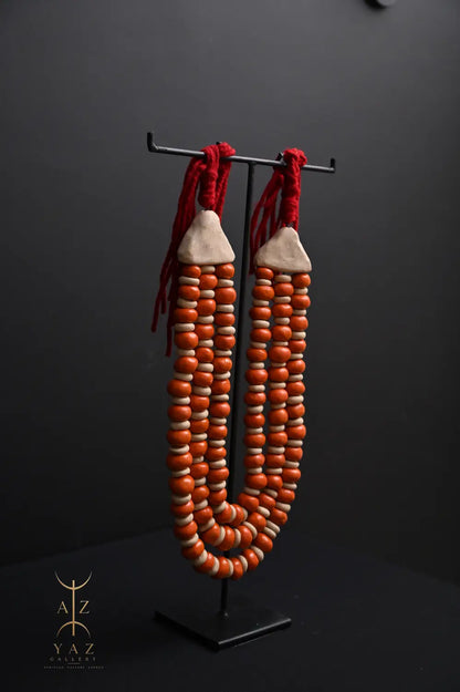 Sunset Ember Pendant Sculpture – Ivory & Orange Beads with Red Rope on Black Stand (62 x 34 cm)