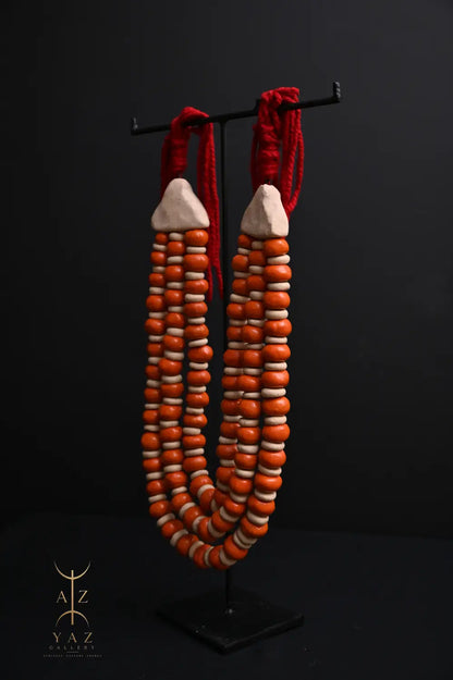 Sunset Ember Pendant Sculpture – Ivory & Orange Beads with Red Rope on Black Stand (62 x 34 cm)