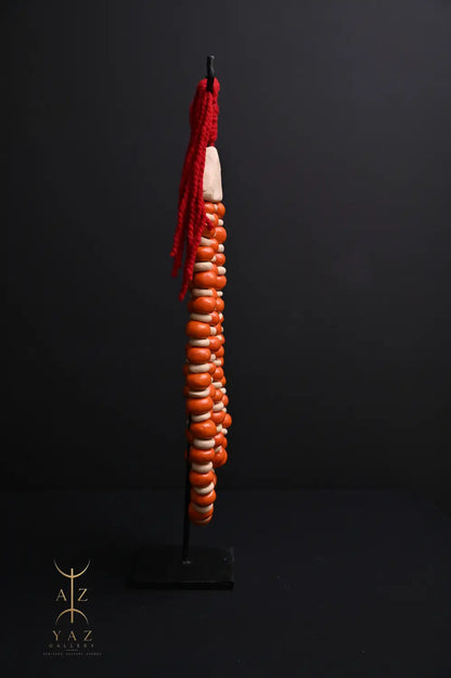 Sunset Ember Pendant Sculpture – Ivory & Orange Beads with Red Rope on Black Stand (62 x 34 cm)
